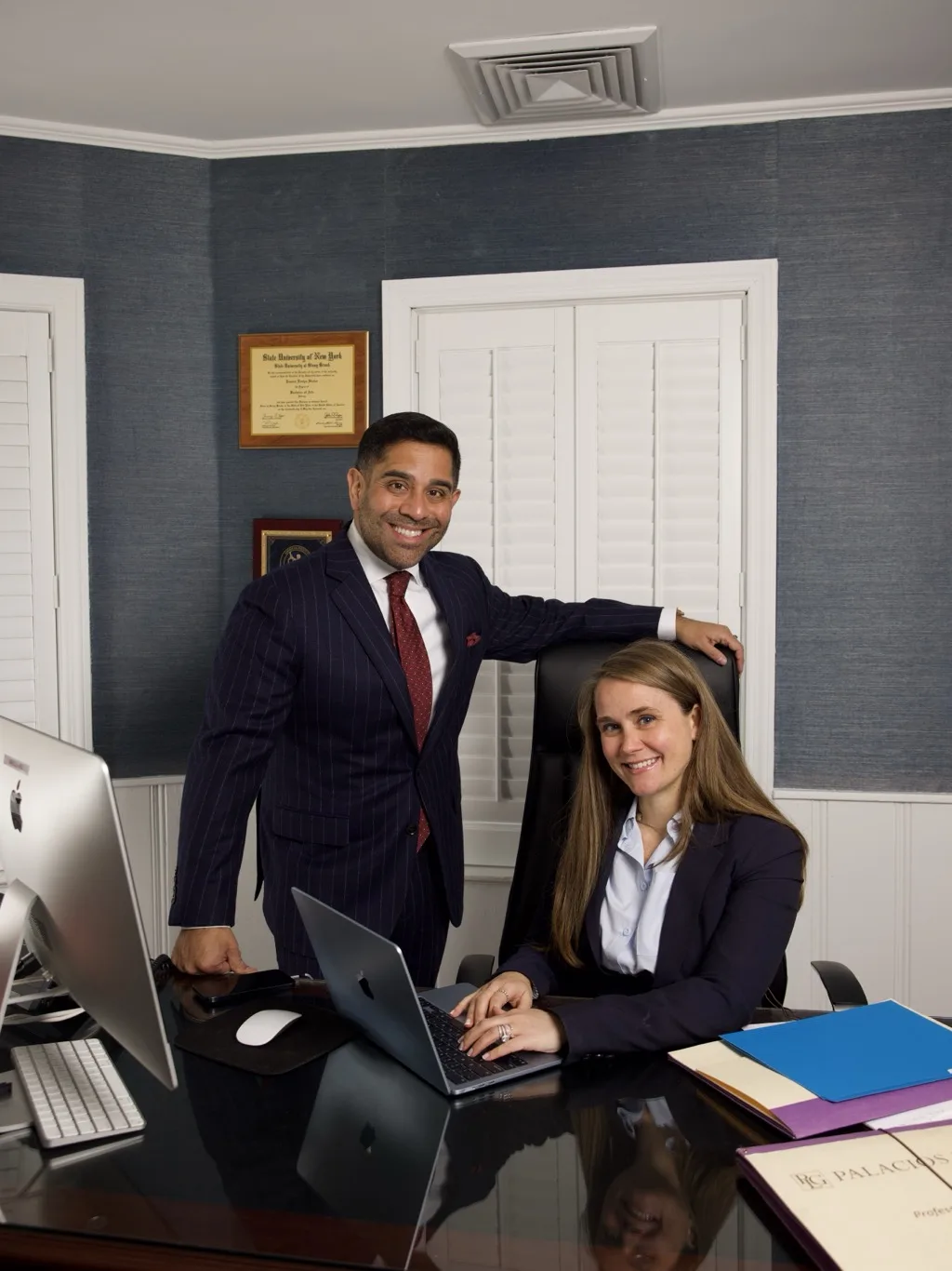 Palacios Law Group attorneys collaborating at a desk in the Long Island office