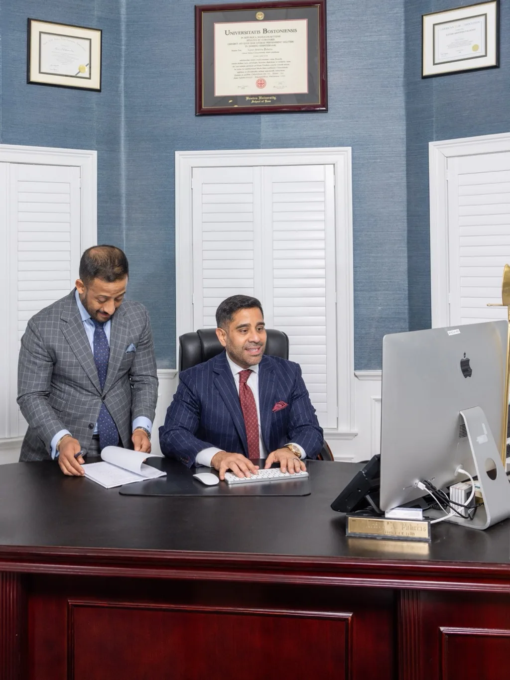 Palacios Law Group attorneys working together at a desk in the Long Island office